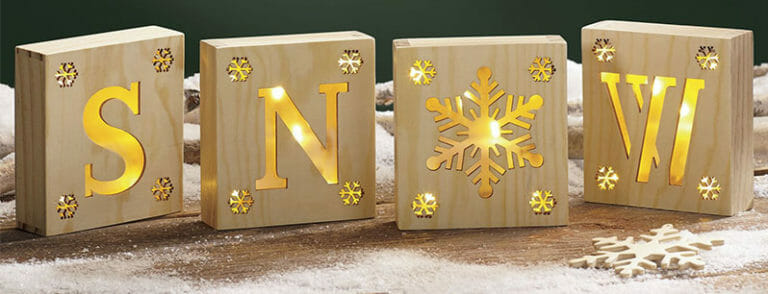 Four blocks with gold letters, S, N, a snowflake, and W.