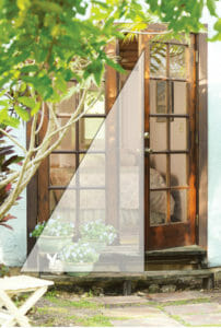 Double wood paned glass patio doors and three planters of flowers, with a screened side triangle overlay.