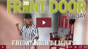 woman dressed as an umpire with a red rocking chair football and black and white striped pillow