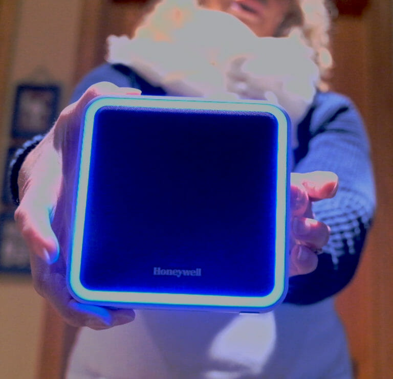 woman holding a wireless doorbell system