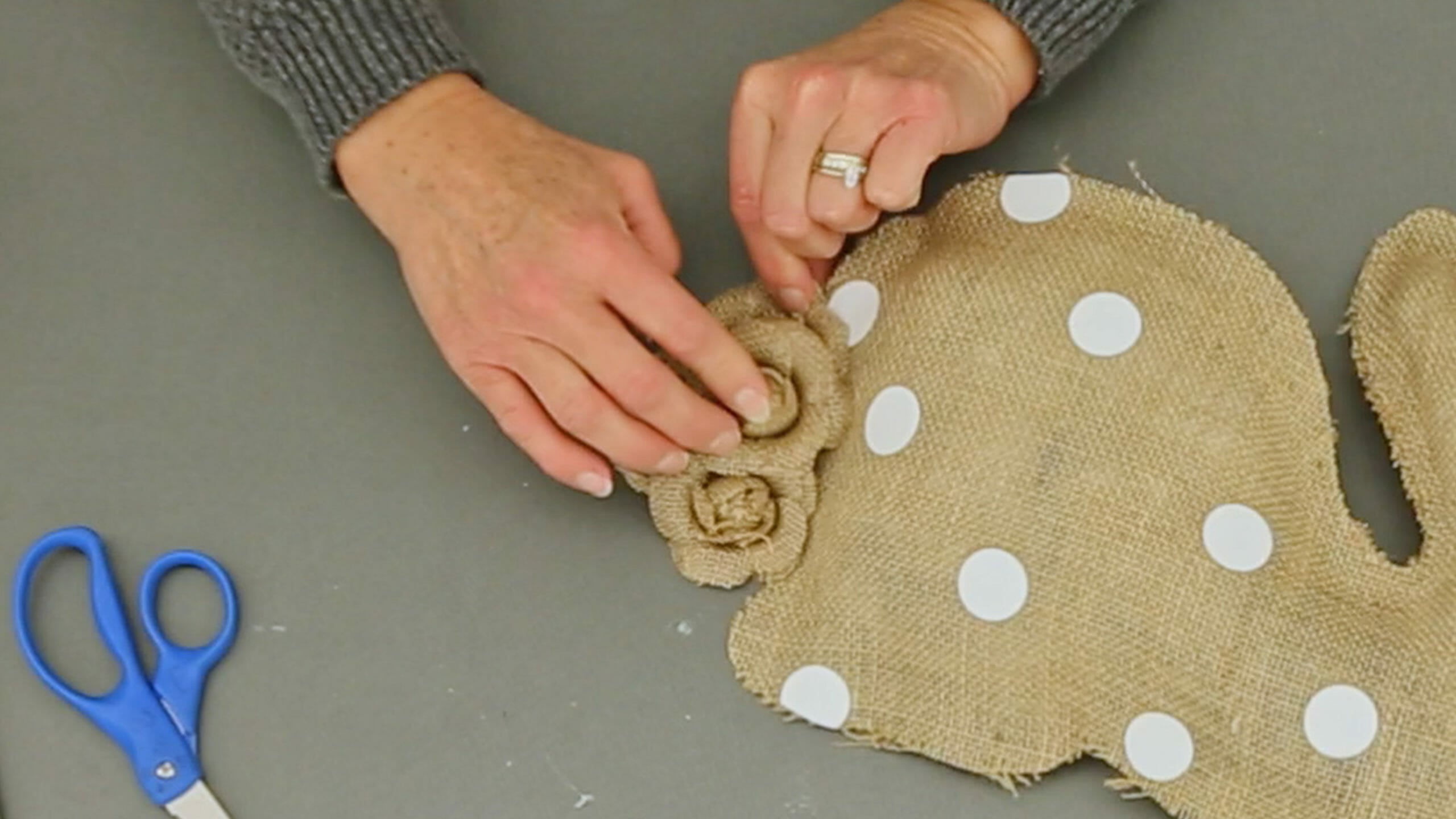 woman making a burlap polka dot bunny pillow