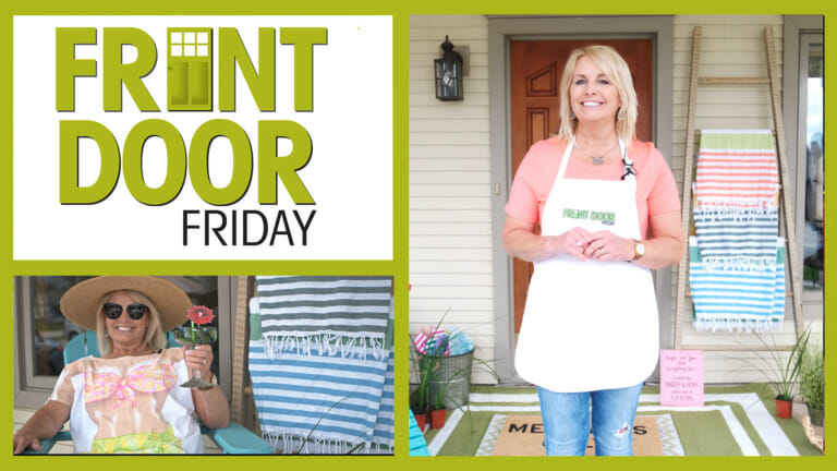 Front Door Friday – Smiling woman with a Tropical drink, on a porch with Coastal Beach decor, and striped rugs on a ladder.