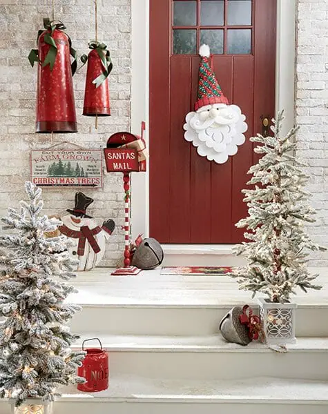 Santa front door hanger, two white flocked trees, two hanging red bells, Santa's mailbox, and large jingle bells.