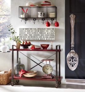 A Farmhouse kitchen in black and red, with a two shelf cart, oversized wall serving spoon, metal wire shelf, accessories.