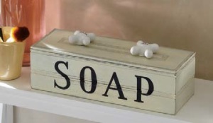A light green rectangular box with a SOAP stencil, and vintage porcelain Hot and Cold knobs on the lid top.