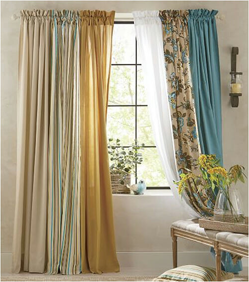 Six different window panels shirred on a single rod, in colors of beige, gold, white, and teal.