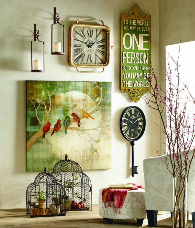Wall art décor including a large green canvas of five birds on a branch, two sconces, two clocks, and a versed plaque.