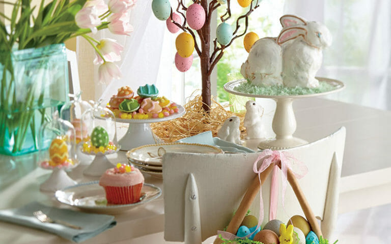 decorative tree adorned with colored Easter eggs sit atop a table to make your Easter décor festive