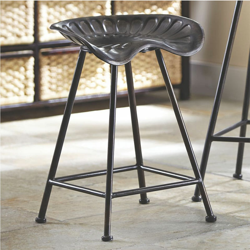 A black metal Farmhouse stool with a vintage tractor seats.