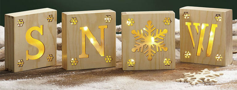 Four blocks with gold letters, S, N, a snowflake, and W.