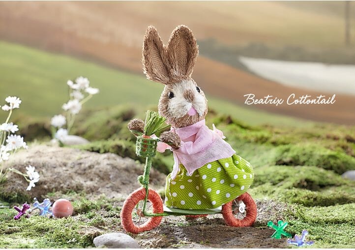 Adorable cottontail baby bunny on a scooter is handmade using natural sisal fibers.