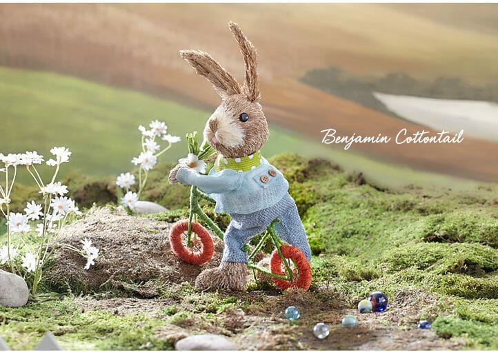 Adorable cottontail baby bunny on a bicycle is handmade using natural sisal fibers.