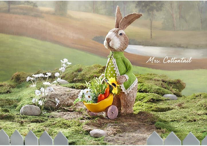 Adorable cottontail bunny pushing a wheelbarrow full of garden vegetabls is handmade using natural sisal fibers.