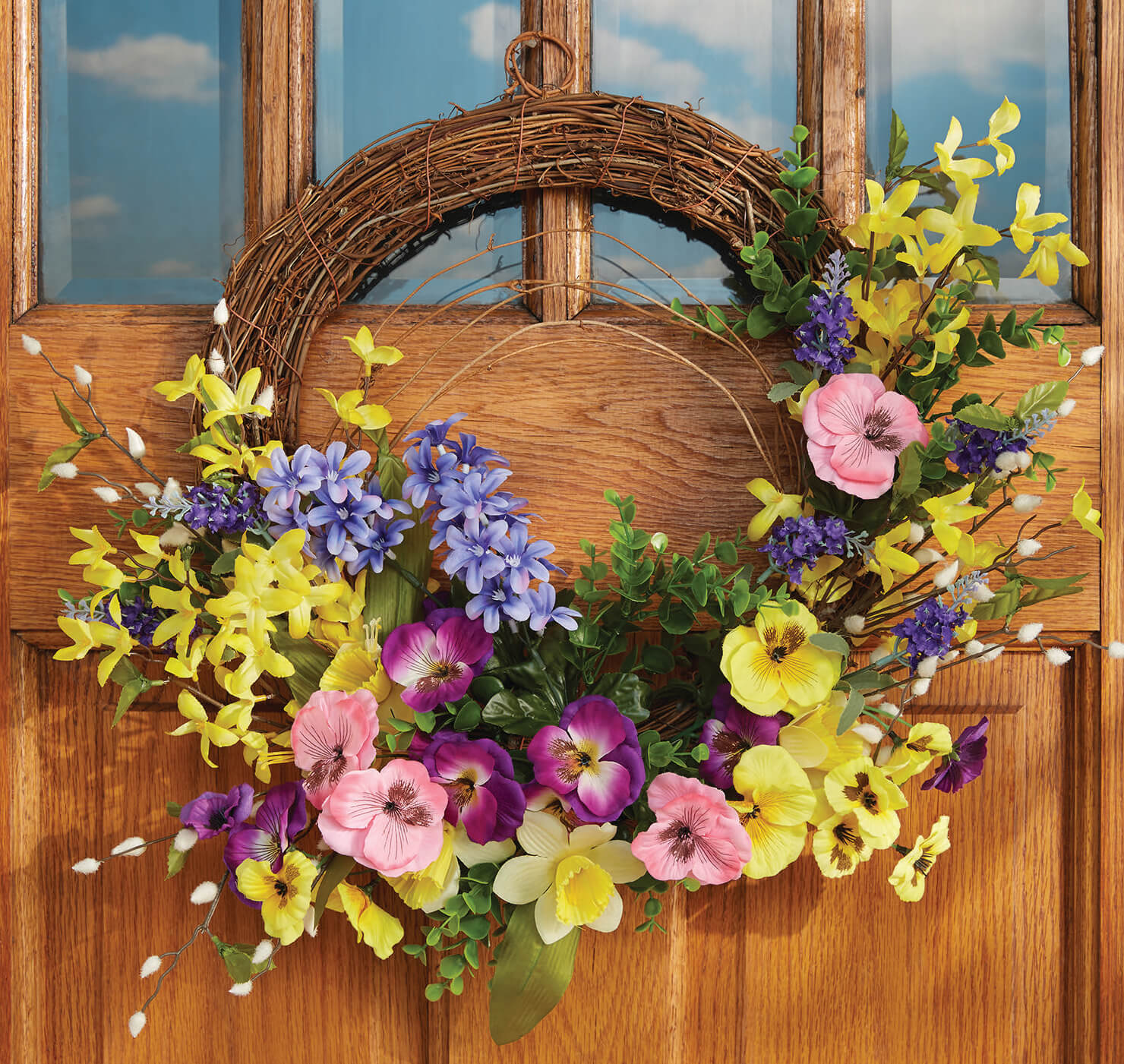 blooming country floral wreath with yellow daffodils, purple and pink pansies, and lavender lilacs