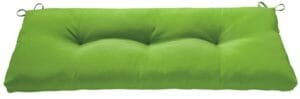 A green tufted bench cushion with ties.