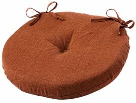 A brown round tufted chair seat cushion with ties.