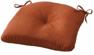 A brown center tufted chair seat cushion with ties.