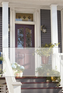 A Victorian home's front porch with stained glass, and potted plants on the steps, with a screened rectangle overlay.