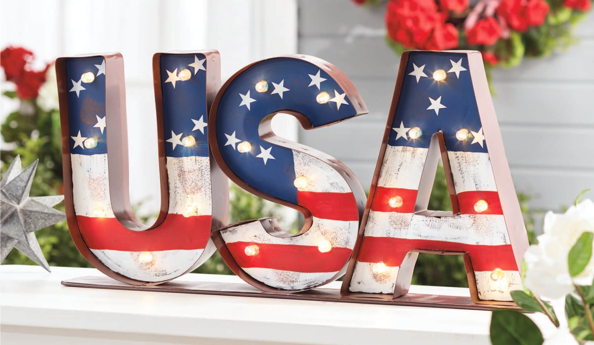 A lit USA marquee light with patriotic red and white stripes and white stars on a blue background.