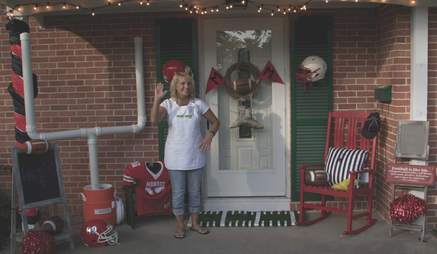 woman on porch with goal post made from pvc, black and white striped pillow, and other football décor