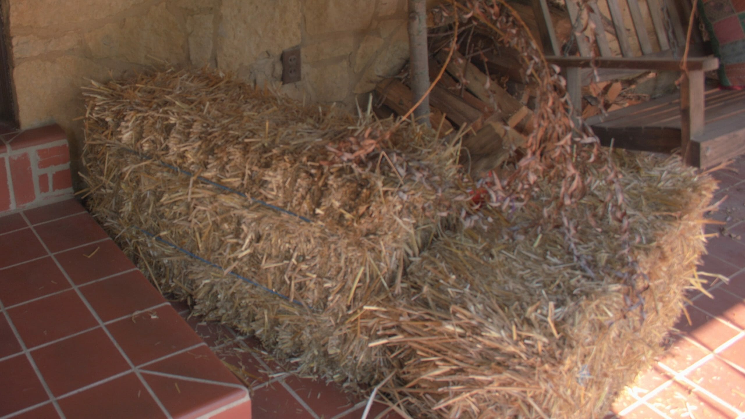 two straw bales on a porch, the start of a fall decorating theme