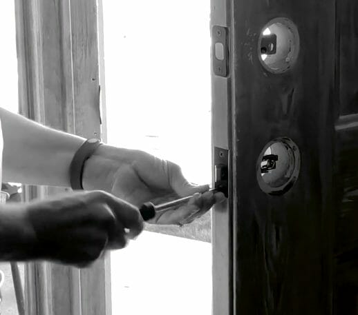 woman replacing door lock