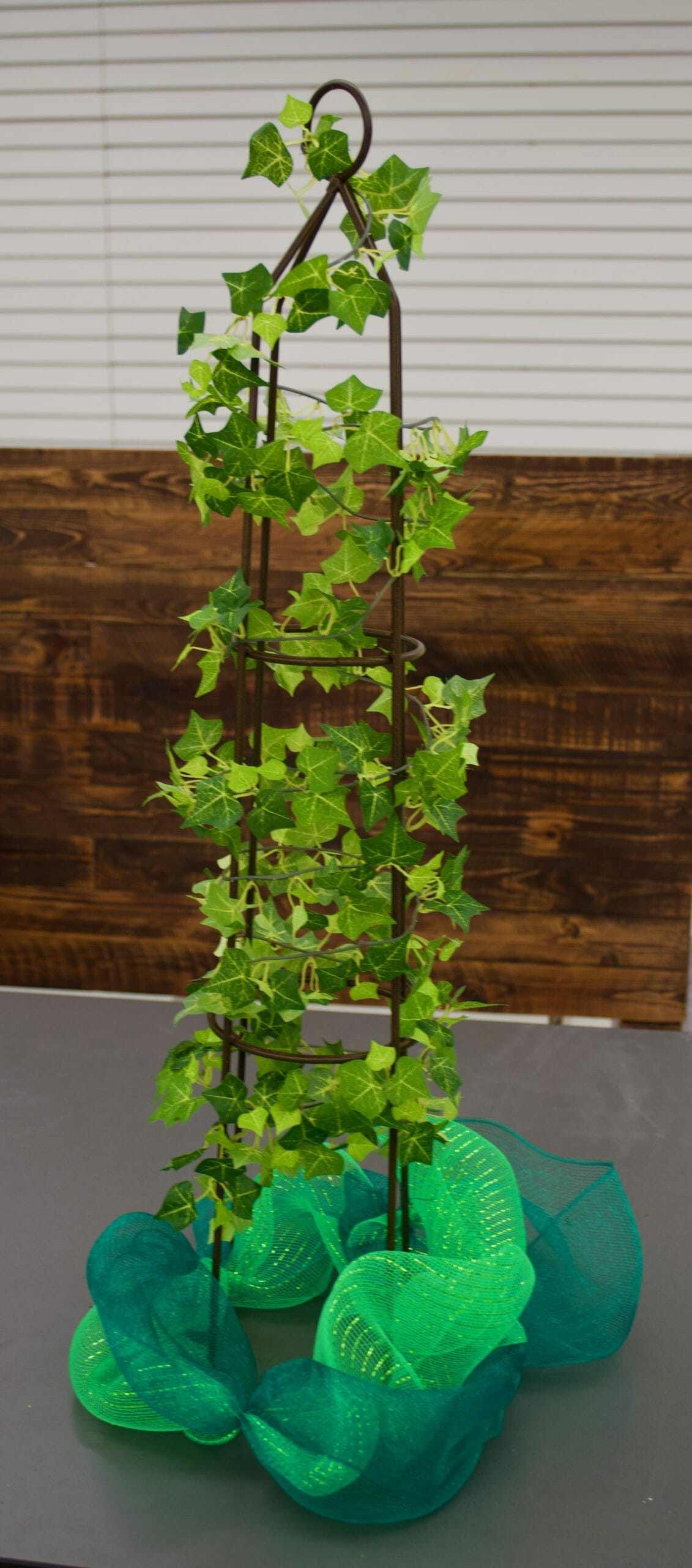 ivy climbing on stand with green mesh garland