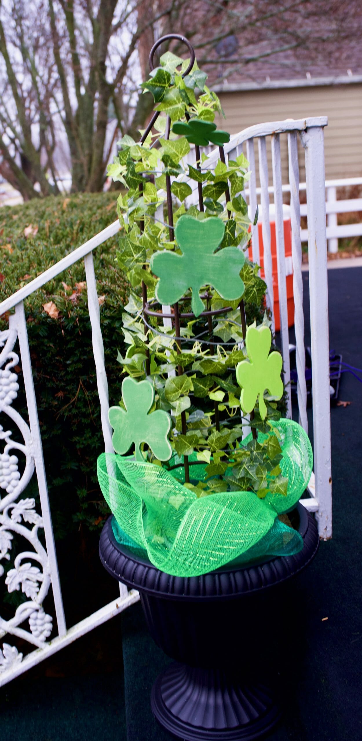 ivy climbing on stand with green shamrocks and green mesh garland décor