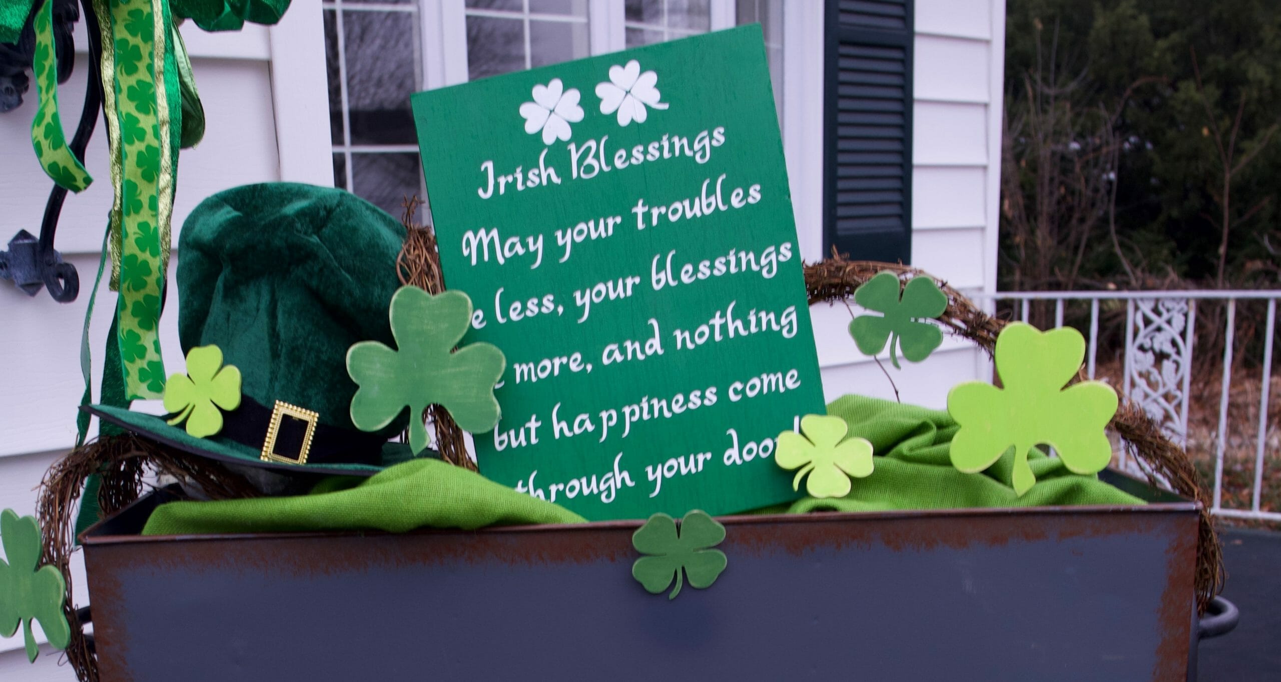 Irish Blessing sign by a Leprechaun's hat and four-leaf clovers to create a St. Patrick's Day front porch