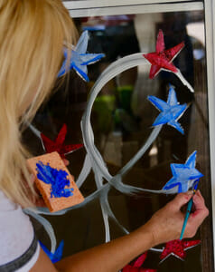painting red, white and blue stars on glass door