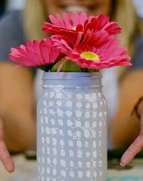 gray painted Mason jar with pink flowers