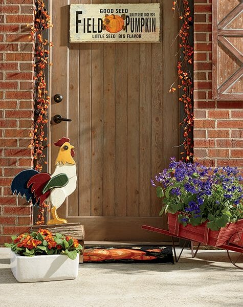 wood cutout rooster by a front door