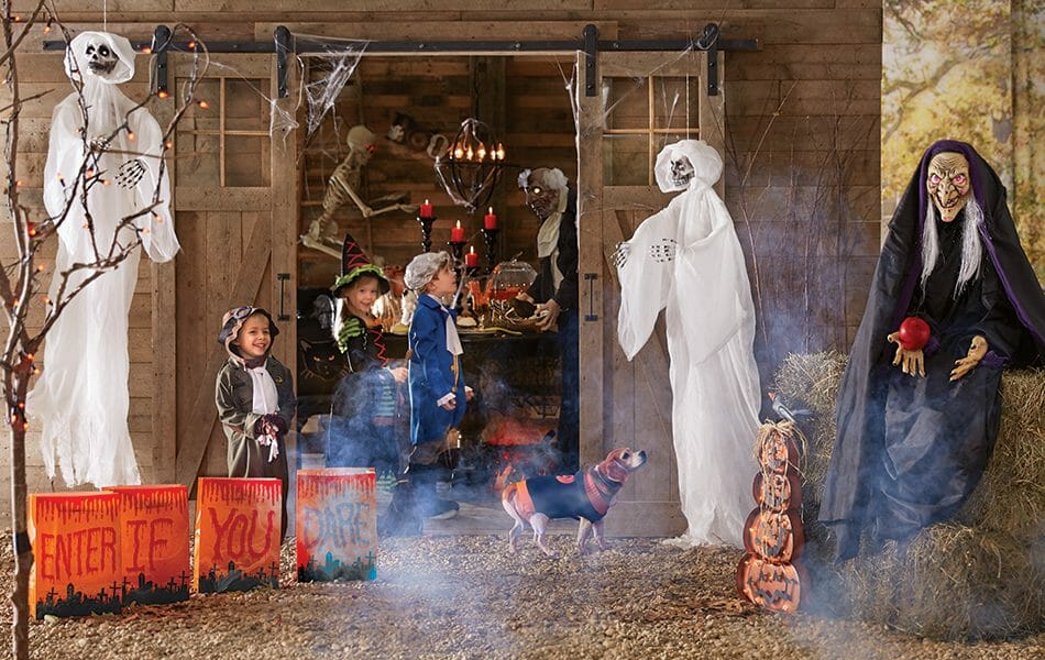 A haunted barn with ghosts, skeletons, a witch with an apple, lit candles and luminaries, and three live trick-or-treaters.