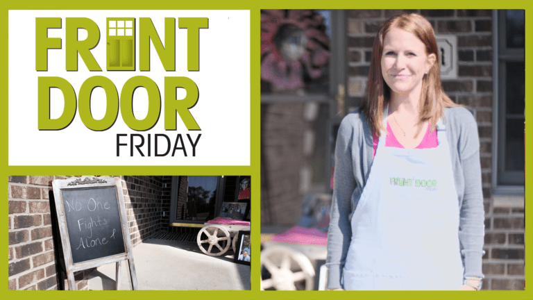 Front Door Friday – Smiling woman on a front porch with chalkboard easel and framed photos for Breast Cancer Awareness.