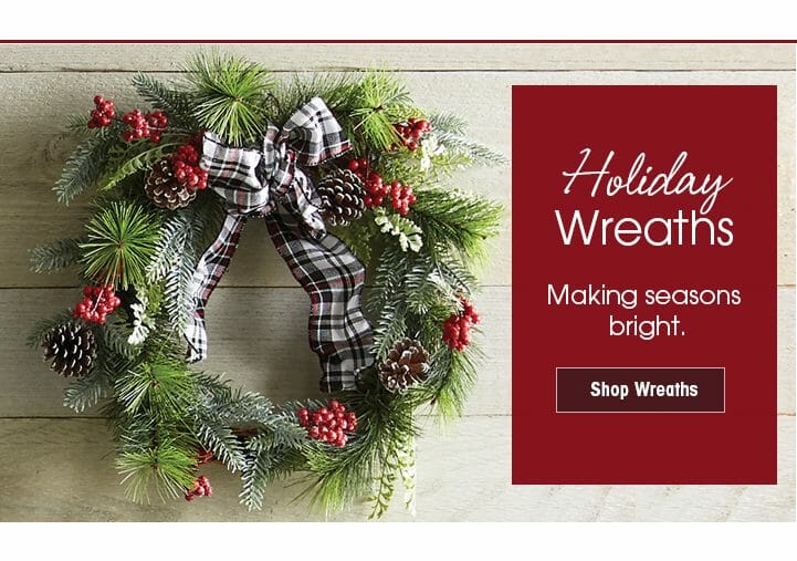 Holiday Wreaths – A traditional pine wreath with a plaid bow, pine cones, and red berries – Shop Wreaths linking button.