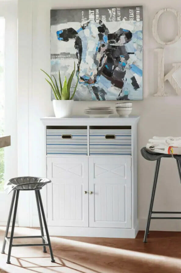 White Cabinet with Cow Wall Art Over IT